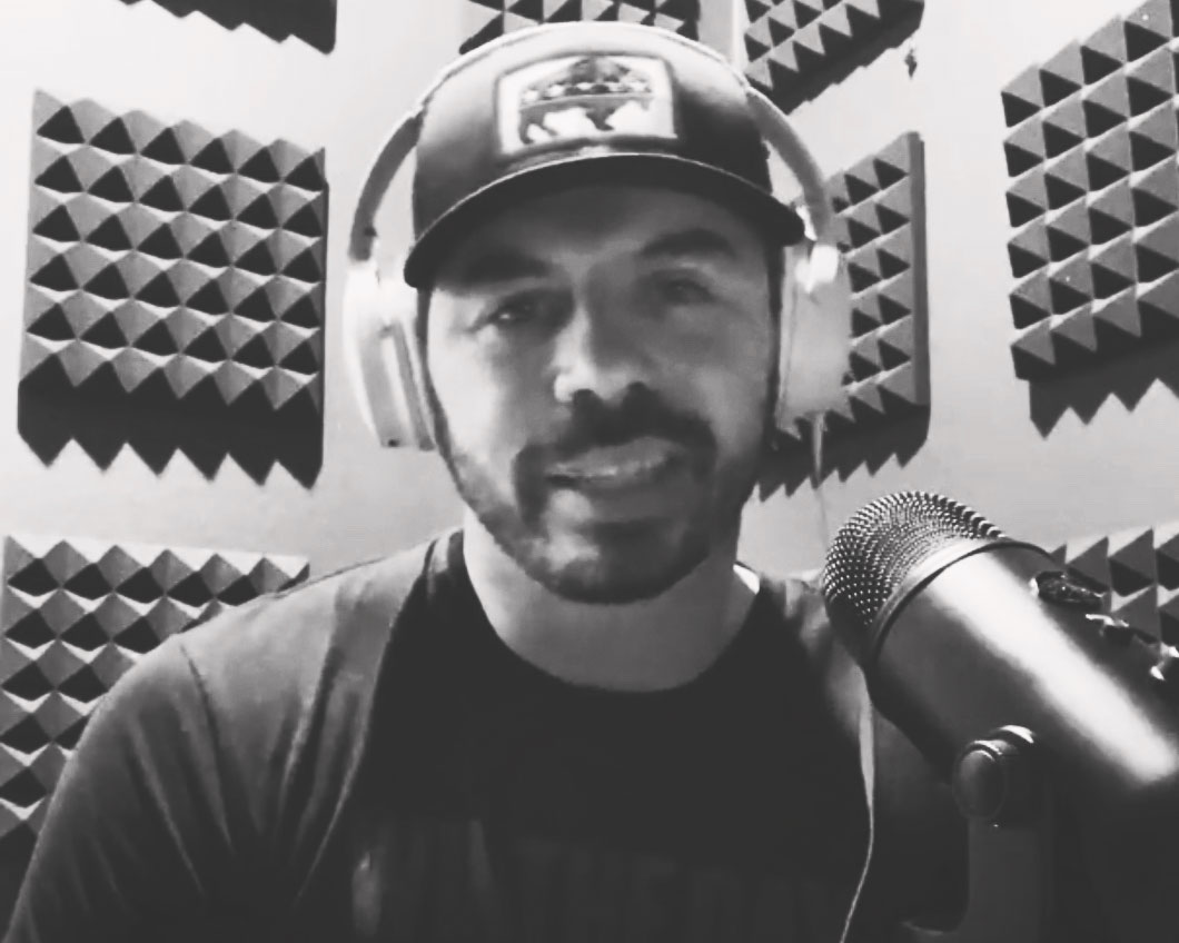 Podcast Chris with headphones in the podcast studio